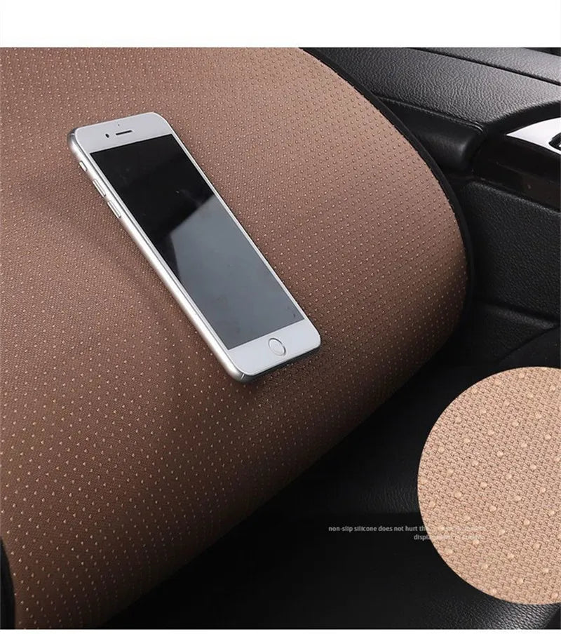 A silver smartphone rests on a brown car seat cushion, highlighting the product's non-slip texture.