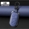 A silver and gold engraved D-shaped key fob attached to a black leather strap.