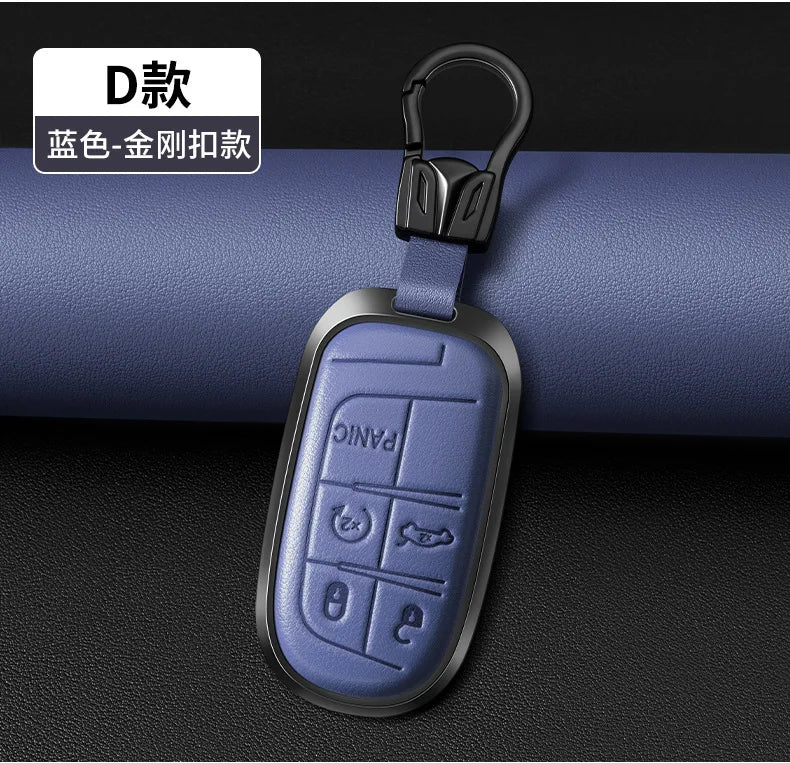 A silver and gold engraved D-shaped key fob attached to a black leather strap.