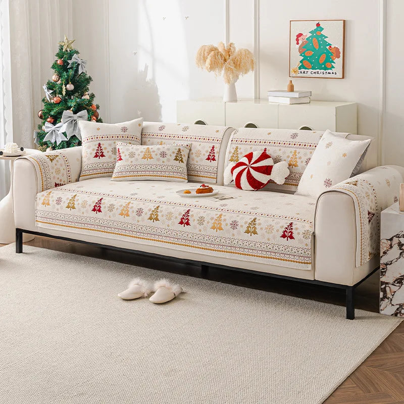 A cream chenille sofa covered with festive Christmas tree patterned fabric and decorative pillows.