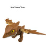 A brown plastic dinosaur toy featuring a Triceratops or Tyrannosaurus design, shown from the side.