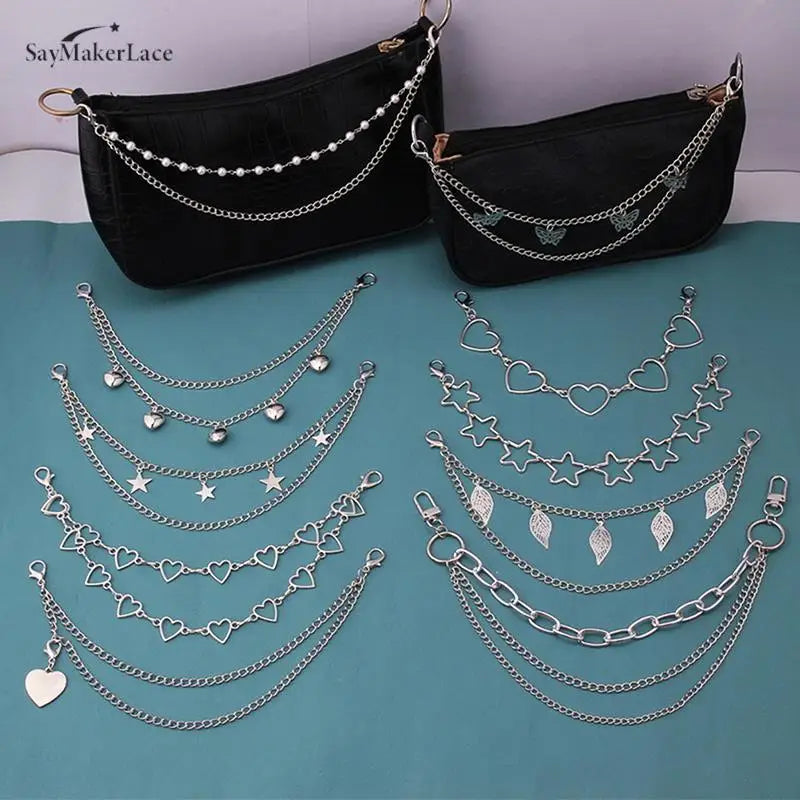 Black velvet purse with multiple layers of silver chain straps and pendant charms