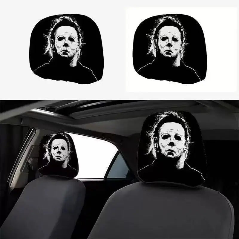 A pair of black car headrest covers featuring a creepy face design.