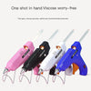 A set of five hot melt glue guns in various colors, including pink, black, white, and blue, with glue sticks visible.