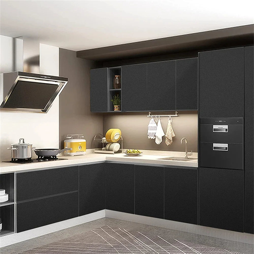 A modern kitchen cabinet and countertop setup with dark gray cabinetry and light countertops.