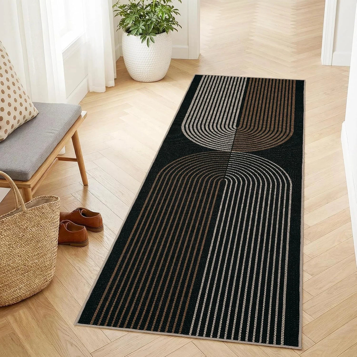 A long runner rug with black and beige geometric stripes on a light wood floor.