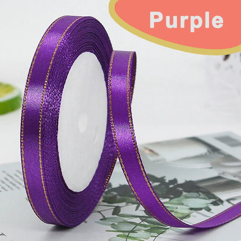 Purple gold-edge satin ribbon rolled for crafts and gift wrapping
