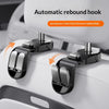 Automatic rebound hook mechanism on a white car seat headrest for secure storage.