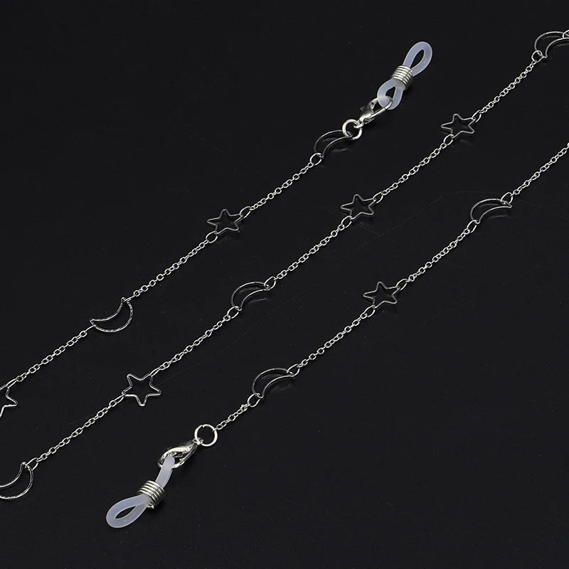 Silver chain necklace featuring a star and moon pendant design