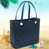 Dunkelblaue, portable EVA-Strandtasche auf goldenem Sand mit Sternensternen und Muscheln.