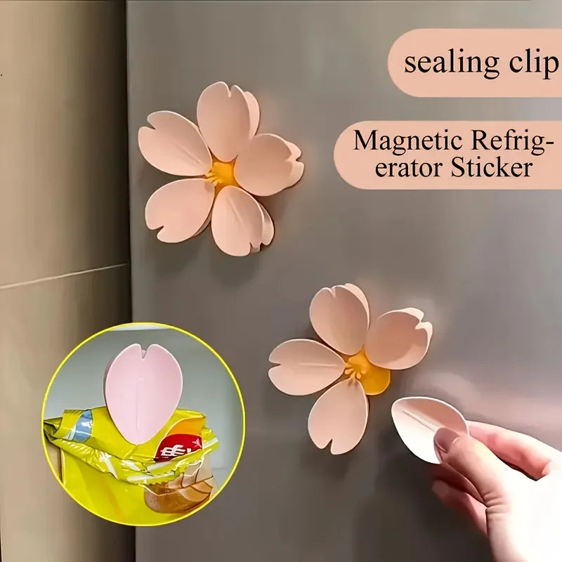 Pink magnetic sealing clips shaped like flowers attached to a refrigerator