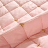 Pink quilted bed skirt with gold embroidery detail