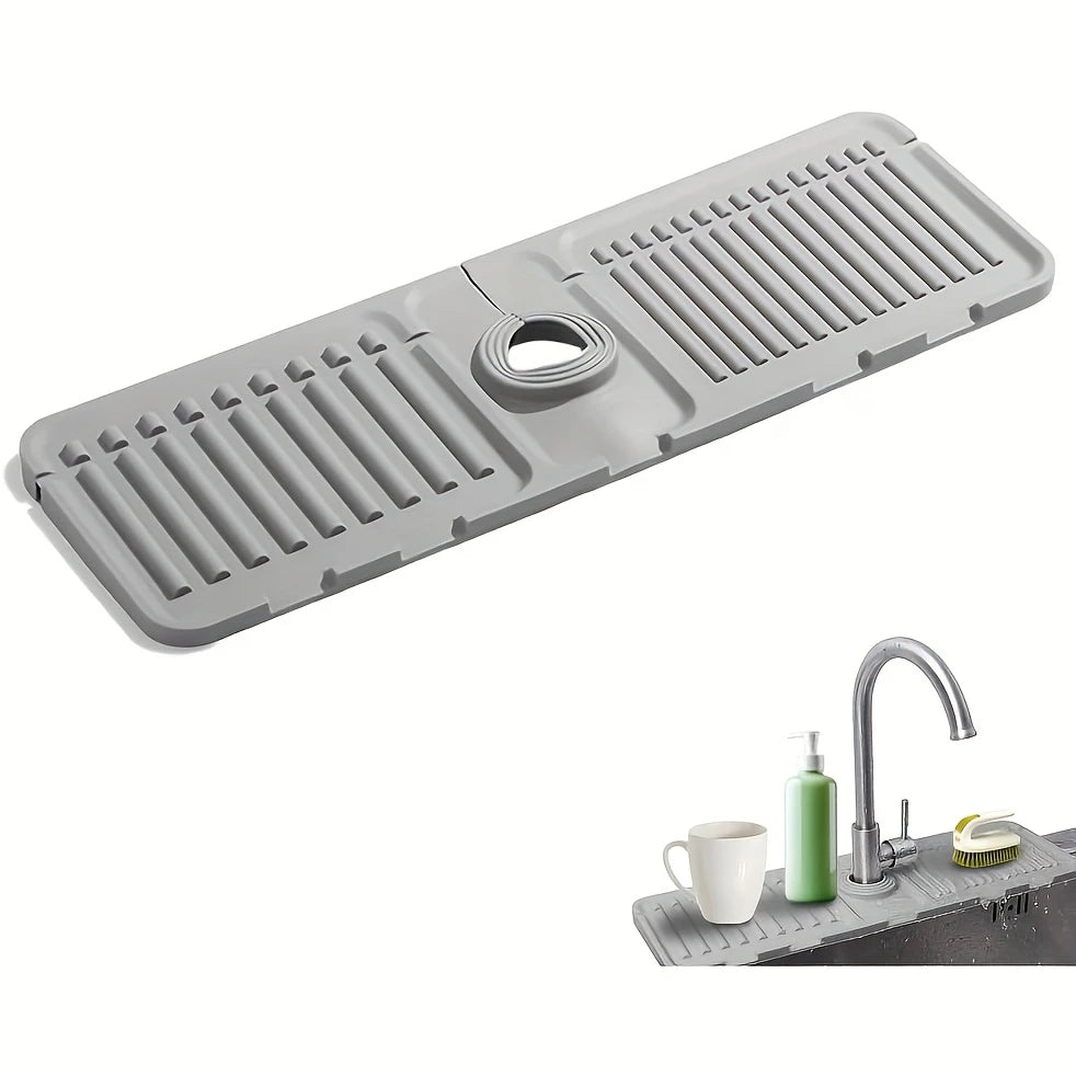 A gray silicone mat with ridges and a central opening used as a splash guard for kitchen or bathroom faucets.