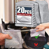 A stack of gray triple-layer microfiber scouring cloths is shown next to a hand holding one cloth.