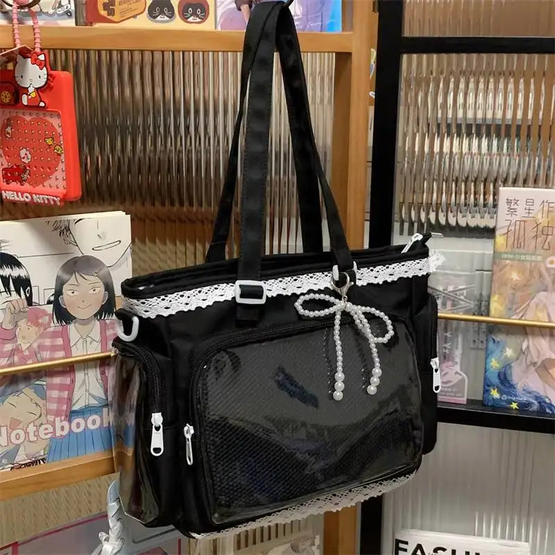 A black transparent shoulder bag with white lace trim and a bow detail displayed in a retail setting.