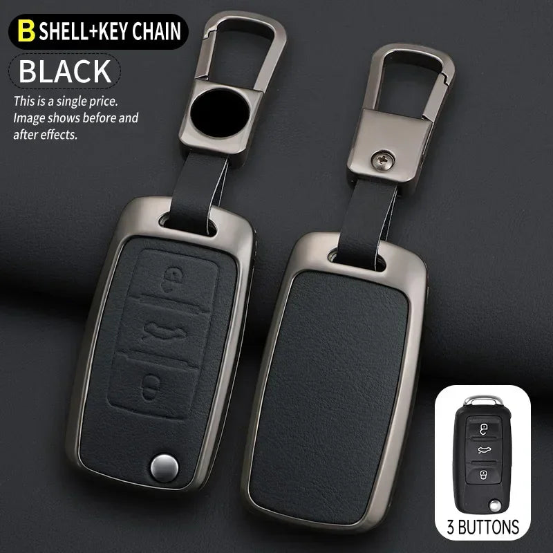 A pair of black B shell key chain covers with metal clasps and three buttons shown against a dark background.