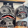 A set of backpacks featuring a shark graphic design printed on US dollar bills.