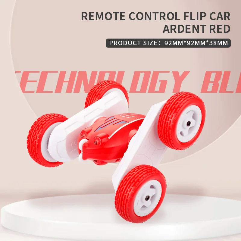 A red remote control flip car with large wheels is shown on a white surface.