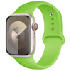 A lime green silicone sport band worn around an Apple Watch.