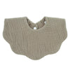A beige knitted baby bib in a bandana style with a rounded neckline.