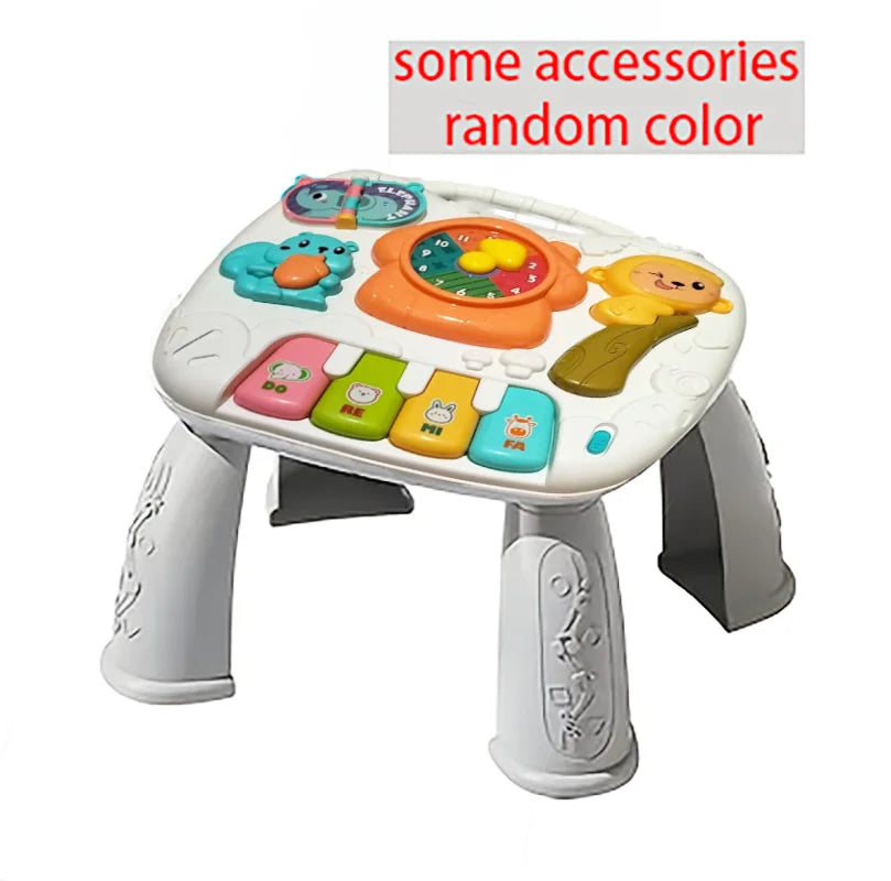 A white baby interactive activity table featuring colorful accessories like a piano and steering wheel.