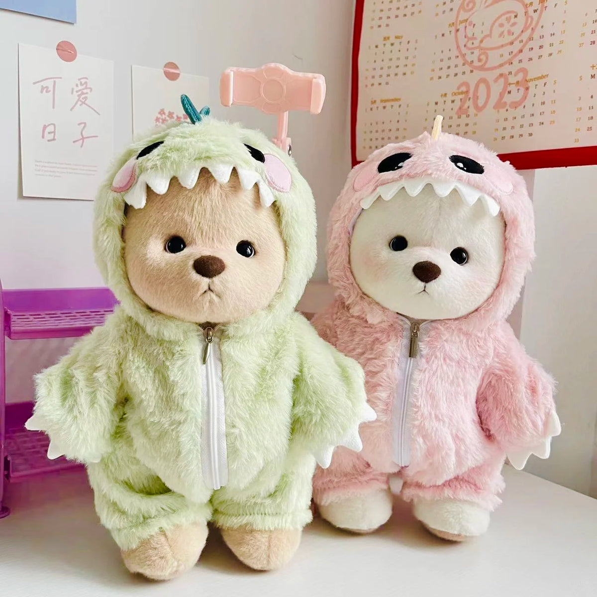 A soft green dinosaur jumpsuit outfit for a medium teddy bear doll with pink accents.