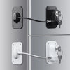 A close-up view of two door locks, one black and one white, with a long cable connecting them.
