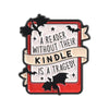 A book lover enamel pin featuring a bat silhouette and text about reading without a kindle being a tragedy