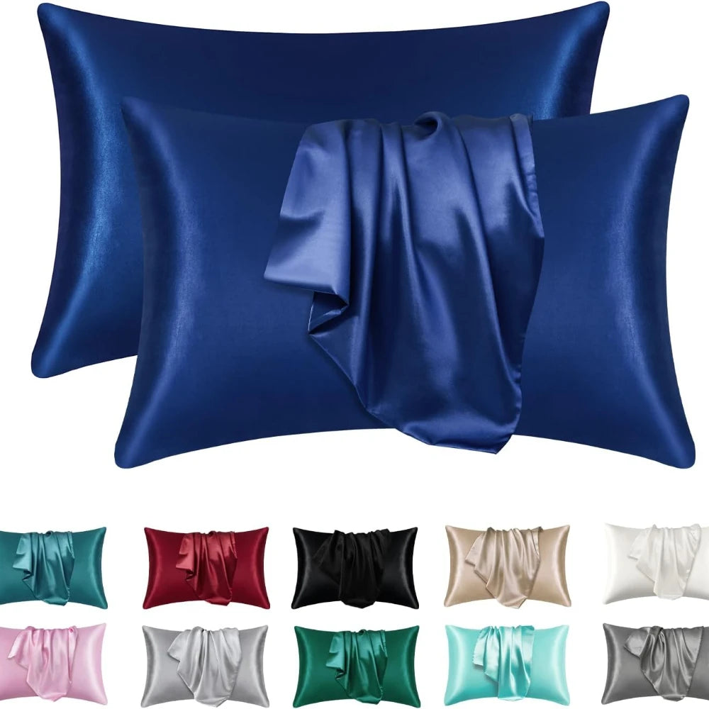Un juego de fundas de almohada de seda satinada en varios tonos, incluyendo azul, verde, rosa y gris.
