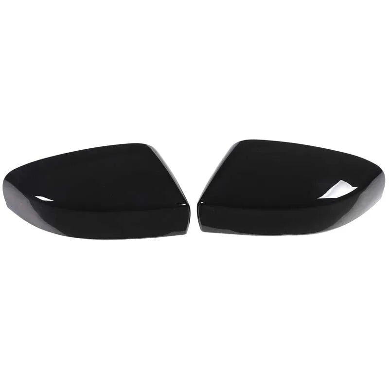 A pair of glossy black carbon fiber side mirror covers for a Maserati Ghibli or Quattroporte.
