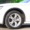 White car wheel with black carbon fiber-look arch trim and tire visible.