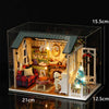 A detailed wooden dollhouse miniature building kit featuring furniture and decorative elements.