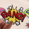 Yellow and red embroidered lettering patch shaped like an explosion with stars and lightning bolts