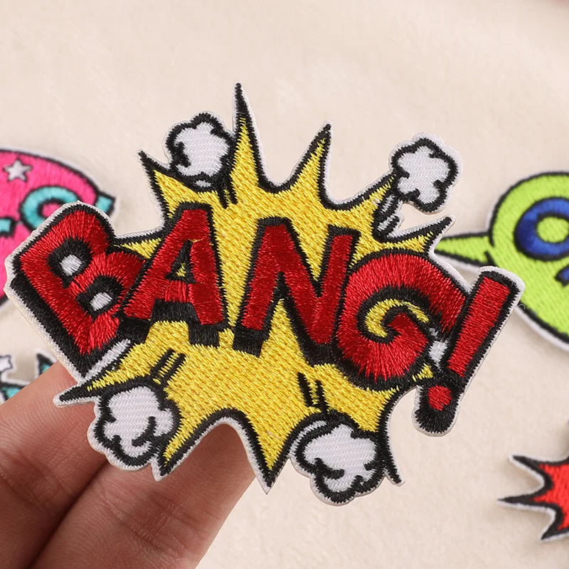 Yellow and red embroidered lettering patch shaped like an explosion with stars and lightning bolts