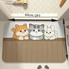 A set of three cute animal figures sitting on a brown bath mat with a non-slip backing.