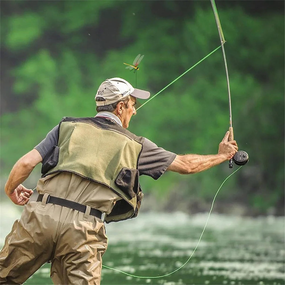 A man is fishing with a long rod in a green outdoor setting.