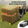 Heavy duty clamp-on pallet forks for tractor and skid steer used to move a large bale of hay.