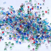 A scatter of colorful decorative stone pebbles including blues, greens, pinks, and whites.