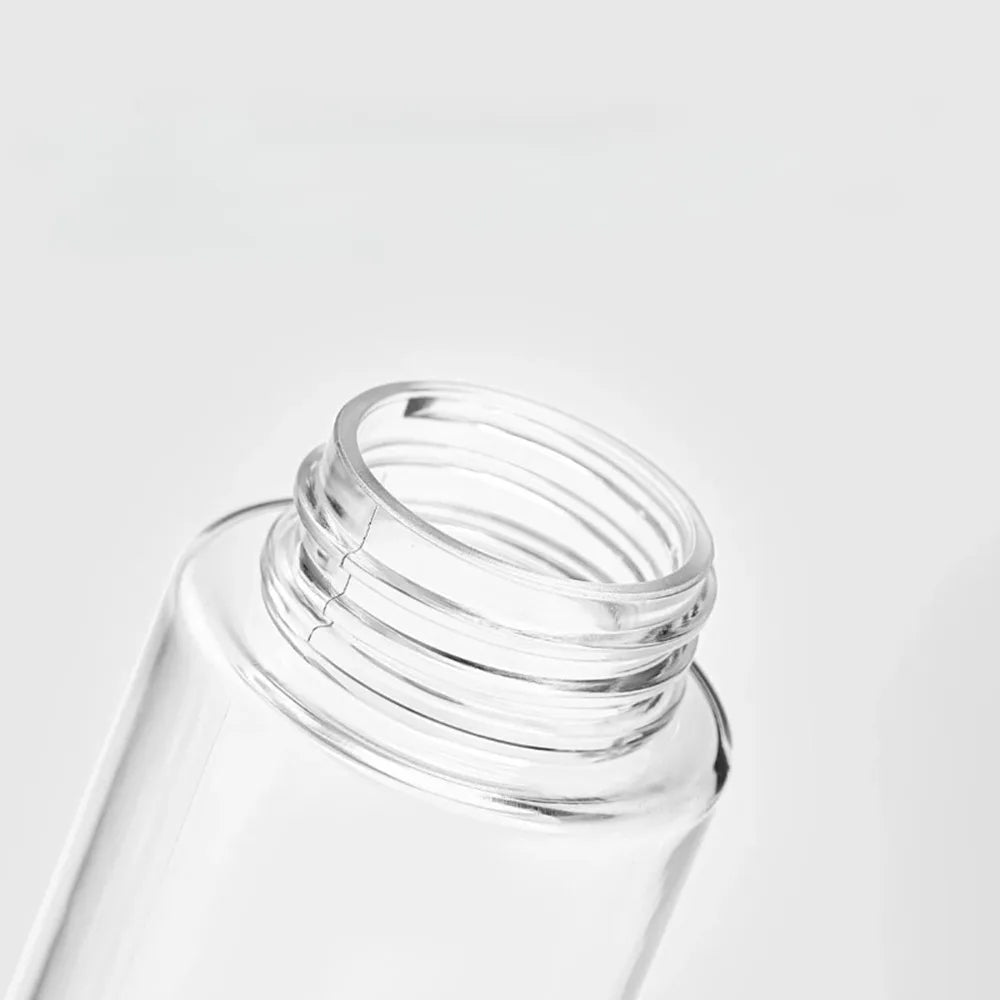 Clear glass refillable fine mist spray bottle with a silver cap