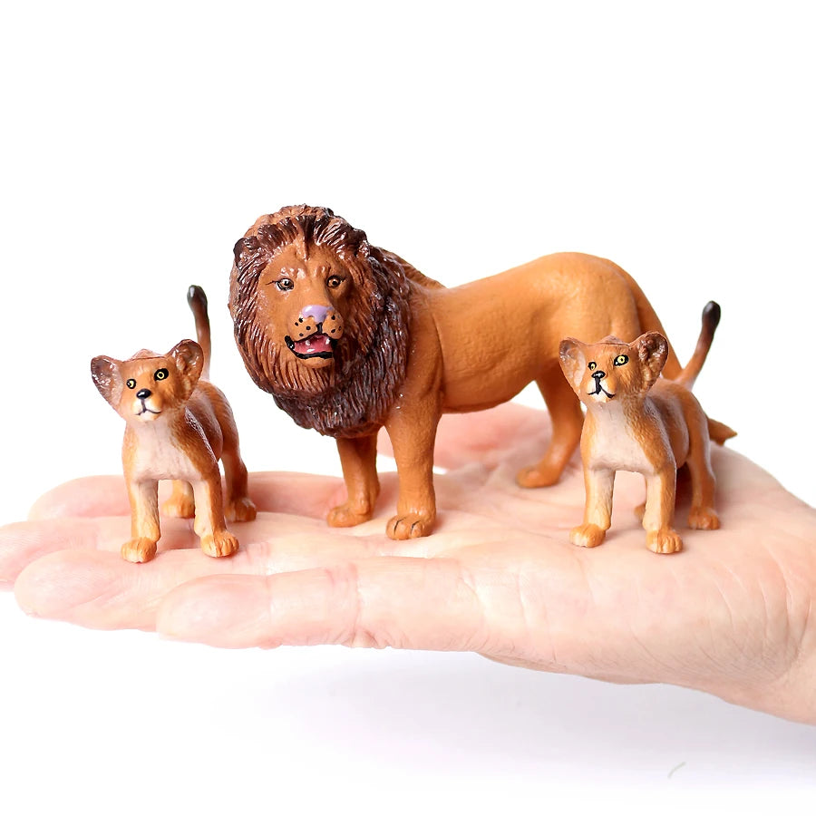 A realistic brown lion figurine is shown next to several small, detailed animal figurines held in a person's hand.