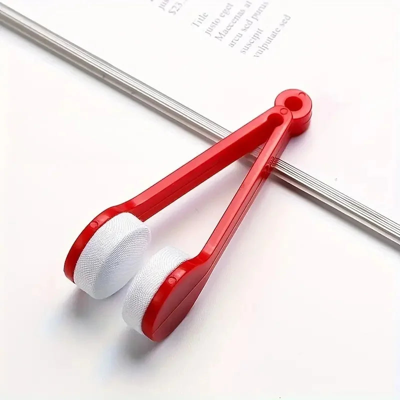 A red eyeglass cleaning kit with a handle and three white microfiber cleaning pads is shown on a white background.