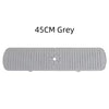 A grey silicone faucet drain mat with ridges and a central drain hole.