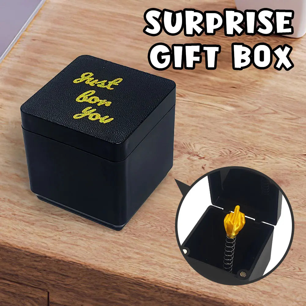A black surprise gift box with gold lettering is shown next to a magnified view of the box's interior.