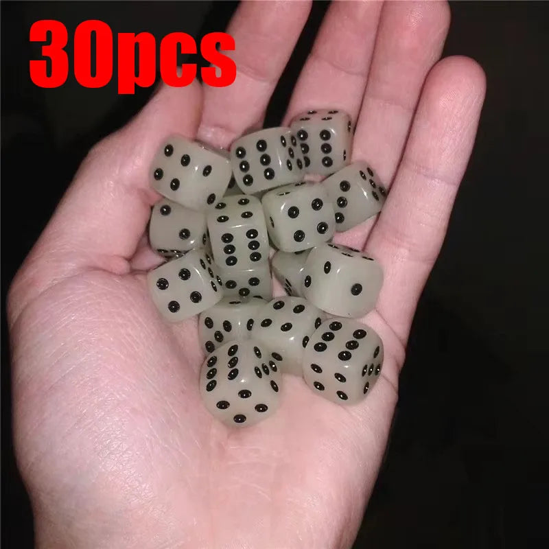 A hand holds a set of 30 glow-in-the-dark acrylic dice for night games.
