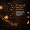 A black cat silhouette and pumpkin decoration on a stake light for Halloween garden decor