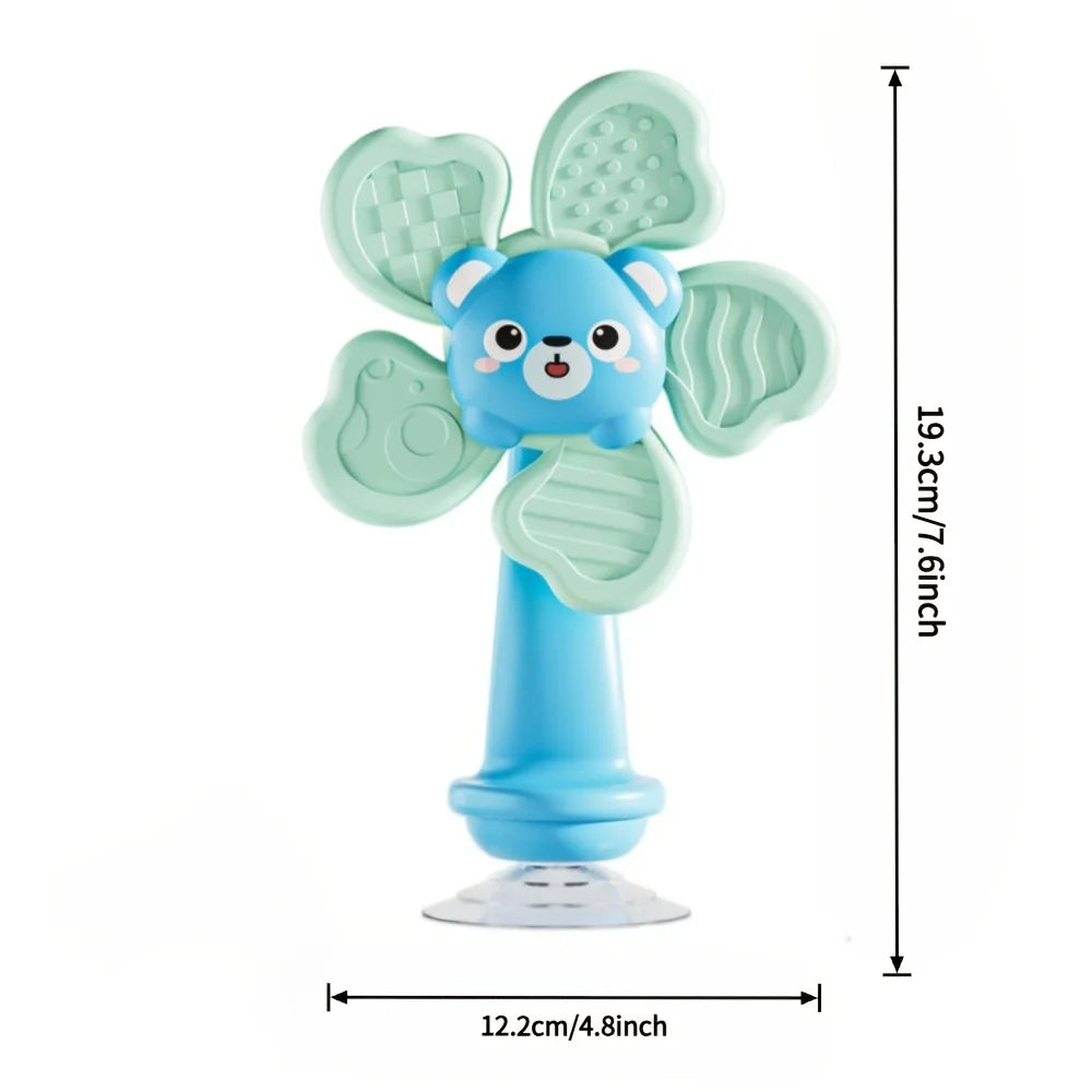 A light blue baby suction cup spinning toy shaped like a cute animal with green leaf-like wings.