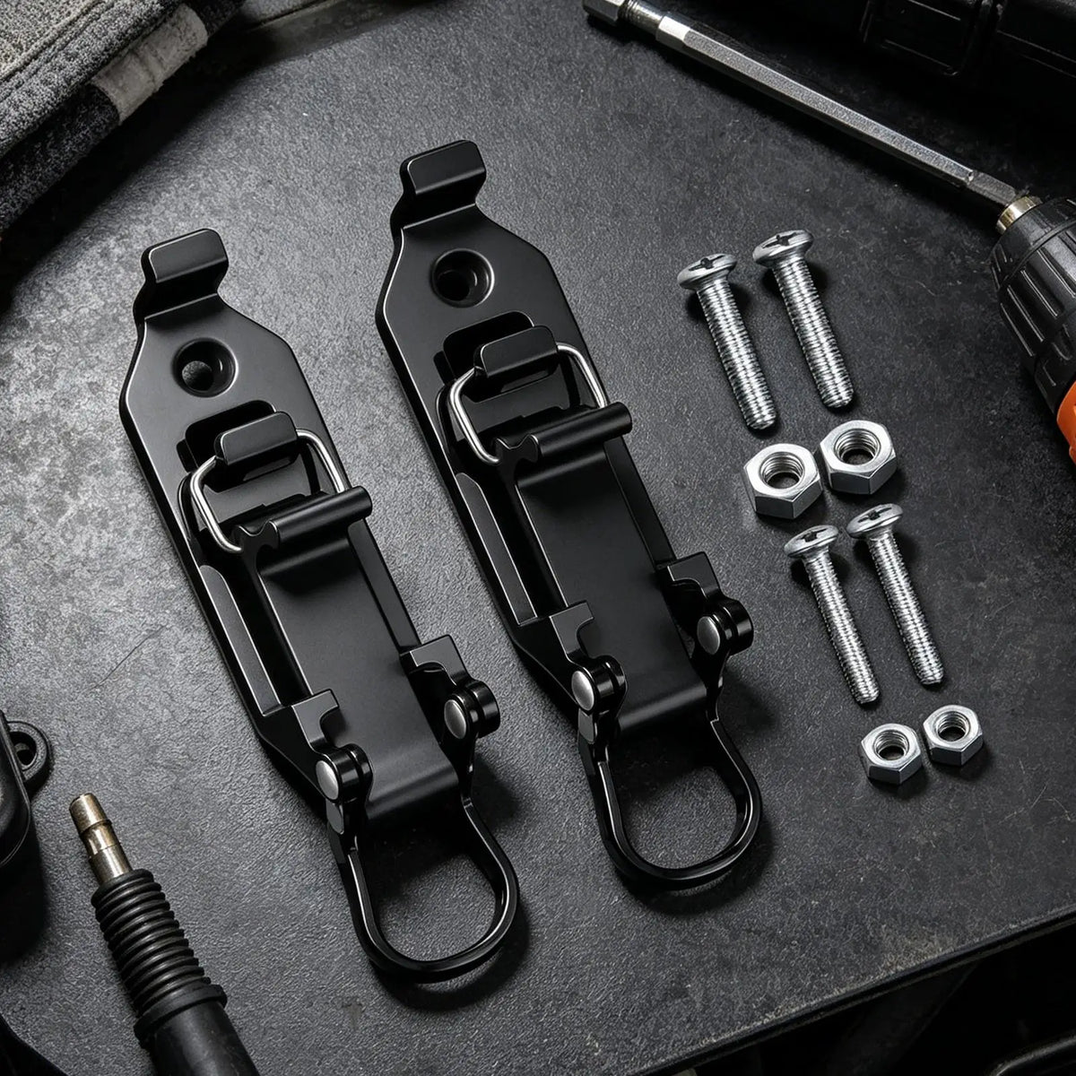 Black heavy-duty quick release shovel holder with mounting hardware displayed on a dark surface