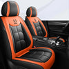 Black and orange leather car seat covers with stitching and design accents shown in a car interior.