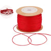 A spool of red nylon cord for jewelry making and crafting with a small roll visible.