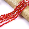Red faceted crystal glass spacer beads strung on a gold-colored cord.